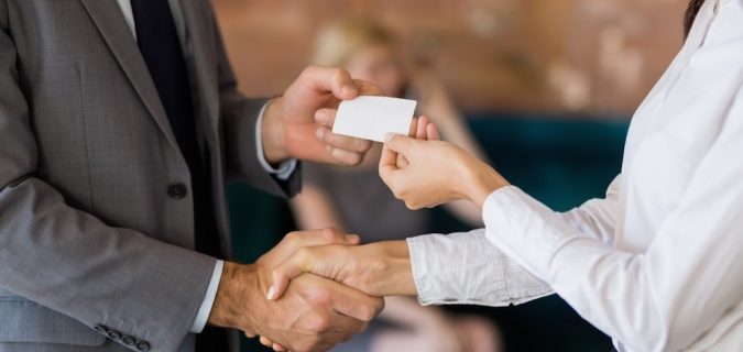 man handing out business card