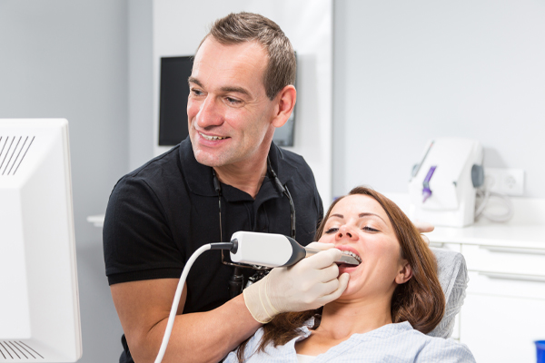 dentist placing composite fillings in patient's mouth