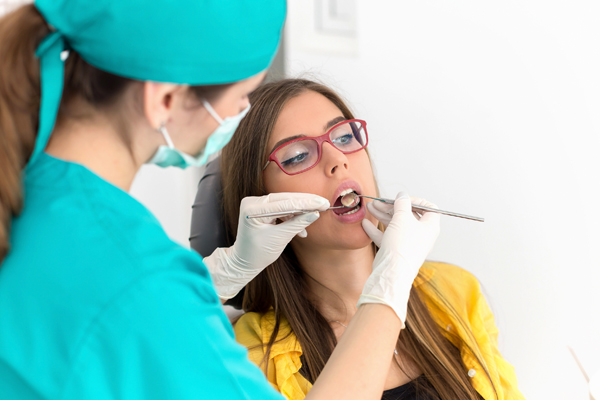 woman with dentist getting a dental cleaning