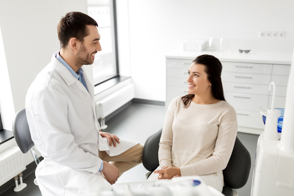 A dentist talking with his patient.